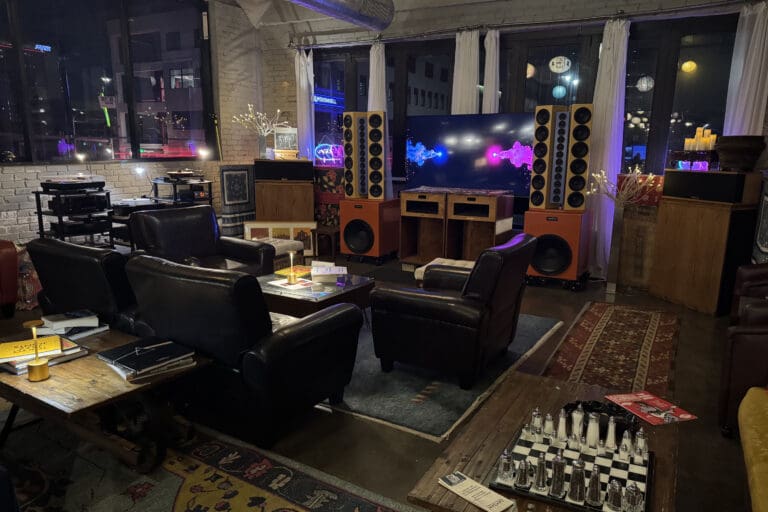 Featured Business June 2026 SoundBar - interior of a music listening room with leather chairs, rugs, speakers and other music paraphernalia.