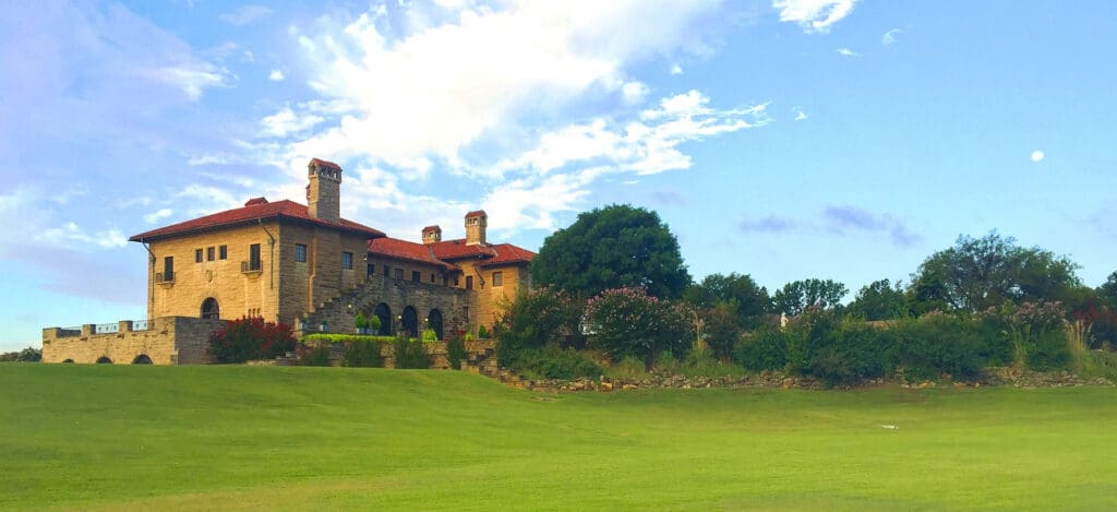 The Marland Mansion - a mansion with lawn and trees surrounding it.
