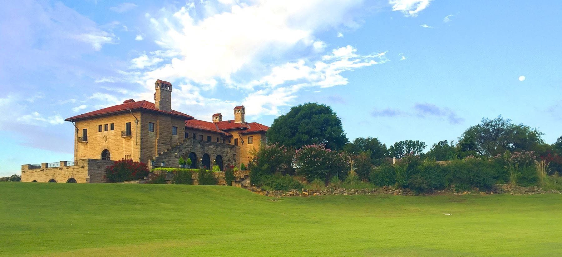 The Marland Mansion - a mansion with lawn and trees surrounding it.